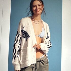 Anthropologie Cream Cardigan with Black Turtle and 'Surf Bound' Detailing